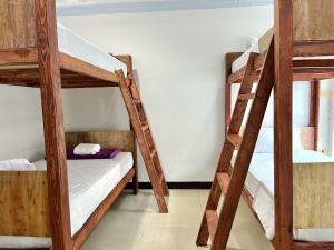 a room with two bunk beds in a hostel at Rest up @ Pattaya Hostel in Pattaya Central