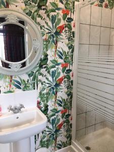 uma casa de banho com um chuveiro, um lavatório e um espelho. em The Forester and Flower em Bath