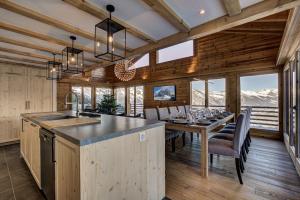 a kitchen and dining room with a table and chairs at Chalet la Chance in La Tzoumaz