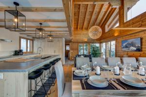 a kitchen and dining room with a table and chairs at Chalet la Chance in La Tzoumaz