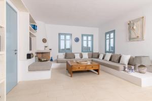 a living room with a couch and a table at VILLA ERIS in Agios Georgios