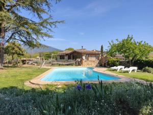 a swimming pool in a yard with a house at Casita con jacuzzi - Rectoria de Dosquers in Maia de Montcal