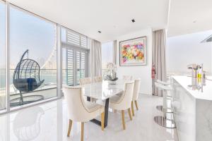 a dining room with a table and chairs with a view at Spectacular 3 BR condo with maids room facing the Dubai Eye in Dubai