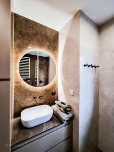 a bathroom with a sink and a mirror at Apartament VIP PROMENADA in Mrągowo