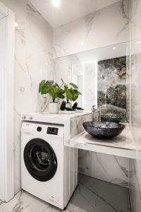 a white laundry room with a washing machine at Charming Studio with Air Conditioning, Old Town & Kazimierz in Krakow