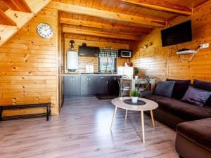 a living room with a couch and a table at Domki letniskowe Nadia 1 in Władysławowo