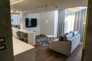 a living room with a couch and a table at Monte 27 Lux Apartments in Sopot