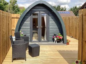 a dog sitting in a gazebo on a patio at The Dalmore Pod in Alness