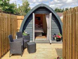 a gazebo with a bed and a dog in it at The Dalmore Pod in Alness