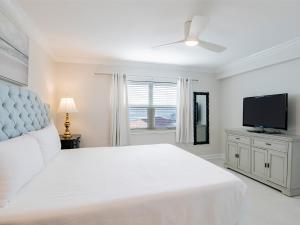 Un dormitorio blanco con una cama y un televisor de pantalla plana. en Regency Towers #708 West, en Pensacola Beach 22 fotos más