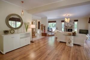 a living room with white furniture and a large mirror at Villa Rina in Nydri