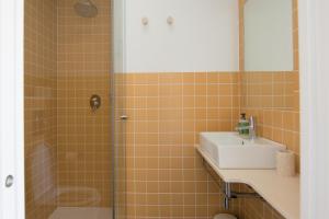 a bathroom with a sink and a shower at Sa Guineu in Cadaqués
