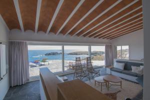 a living room with a view of the ocean at Sa Guineu in Cadaqués