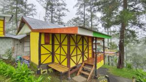 a small house with a bench in front of it at IEFA Malino Resort in Malino