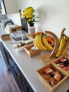 a kitchen counter with baskets of fruit and bananas at St Breca in Newquay