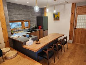 a kitchen with a large wooden table and chairs at IRIRU Luxury Hanok Stay - Eunpyung Hanok village in Seoul