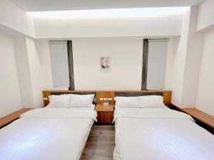 Postel nebo postele na pokoji v ubytování 寬品居站前電梯民宿近花蓮火車站好停車寵物友善Kuan Pin Ju B&B