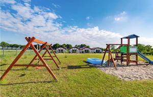 a group of playground equipment in a field at Cozy Home In Jaroslawiec With Wifi in Jarosławiec