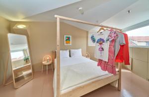 a bedroom with a canopy bed and a mirror at Design Hostel One in Split