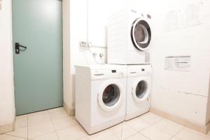a white laundry room with a washer and dryer at Adriano Residence - by Adriano Group in Bologna +63 photos