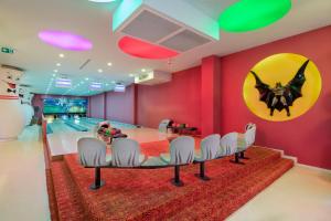 a bowling alley with a table and bowling lanes at Granada Luxury Okurcalar in Okurcalar