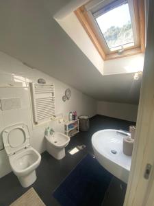 a bathroom with a white toilet and a sink at Bogliasco Wine Loft in Bogliasco