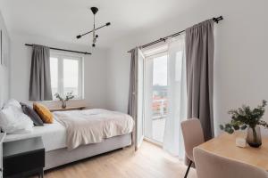 a bedroom with a bed and a large window at Sunny Condo in Holešovice by Prague Days in Prague