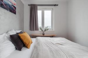 a bedroom with a bed and a window at Sunny Condo in Holešovice by Prague Days in Prague
