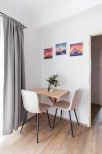 a dining room with a table and two chairs at Sunny Condo in Holešovice by Prague Days in Prague