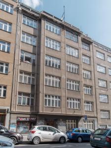 a large building with cars parked in front of it at Sunny Condo in Holešovice by Prague Days in Prague