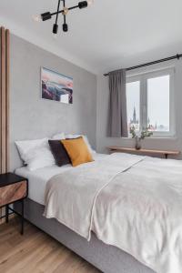 a bedroom with a large bed and a window at Sunny Condo in Holešovice by Prague Days in Prague