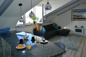 a living room with a table and a couch at Sandybanks Torquay - Seaview and Promenade Apartments in Torquay
