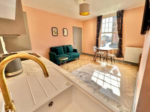 a kitchen with a sink and a living room at The Bradley in Market Weighton