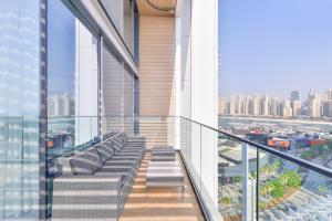 a balcony of a building with a couch on it at Luxe 3 BR Oceanfront Apt with maids room in the heart of Bluewaters Island in Dubai