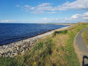 a path along the shore of a rocky beach at Coastal Cottage in Dromore West