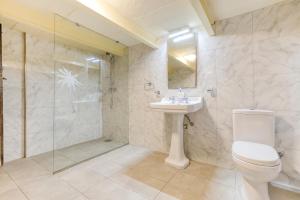 a bathroom with a toilet and a sink and a shower at VLT214- Valletta 2 Bedroom Townhouse in Valletta