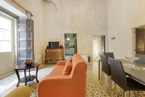 a living room with a couch and a table at VLT214- Valletta 2 Bedroom Townhouse in Valletta