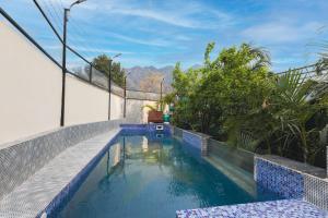 a swimming pool in the middle of a house at Yogved Hospitality & Resort in Rishīkesh