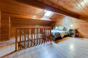 a attic bedroom with a bed and a wooden wall at Poppy's Pad - Winchester Road in Liverpool
