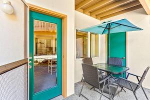 a patio with a table and chairs and an umbrella at Alpine Oasis in Leavenworth