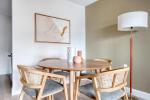 a dining room table with chairs and a lamp at Allston 2br nr Boston U Green Line BOS-824 in Boston