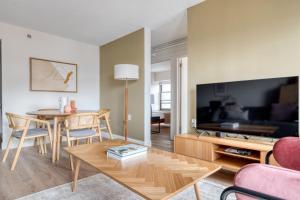 a living room with a table and a tv at Allston 2br nr Boston U Green Line BOS-824 in Boston