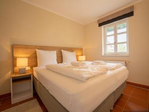 Postel nebo postele na pokoji v ubytování Feriendorf Rugana - Komfortplus Appartement mit 1 Schlafzimmern und Terrasse D46
