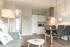 a living room and kitchen with a table and chairs at Villa Marin Wohnung 23 in Zinnowitz