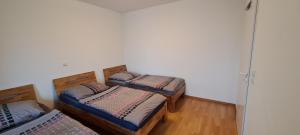 a room with three beds in a room at Equipment of Good And Night in Neuss