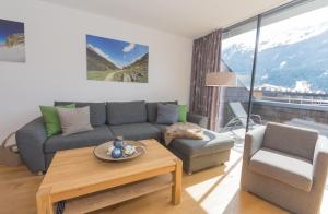 a living room with a couch and a table at Apartment am Sonnenhang - Top 3 in Neukirchen am Großvenediger