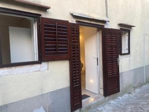 an open window on the side of a building at 4* Posta / Butiga couples only apartments in Vrbnik
