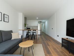 ein Wohnzimmer mit Sofa und Tisch in der Unterkunft Radiant Beach Accommodation in Guanarteme