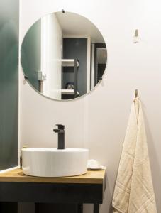 a bathroom with a white sink and a mirror at Club del Sole Rimini Family Resort in Rimini