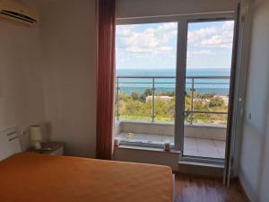 a room with a large window with a view of the ocean at Milana-2 Sea View in Byala +39 photos